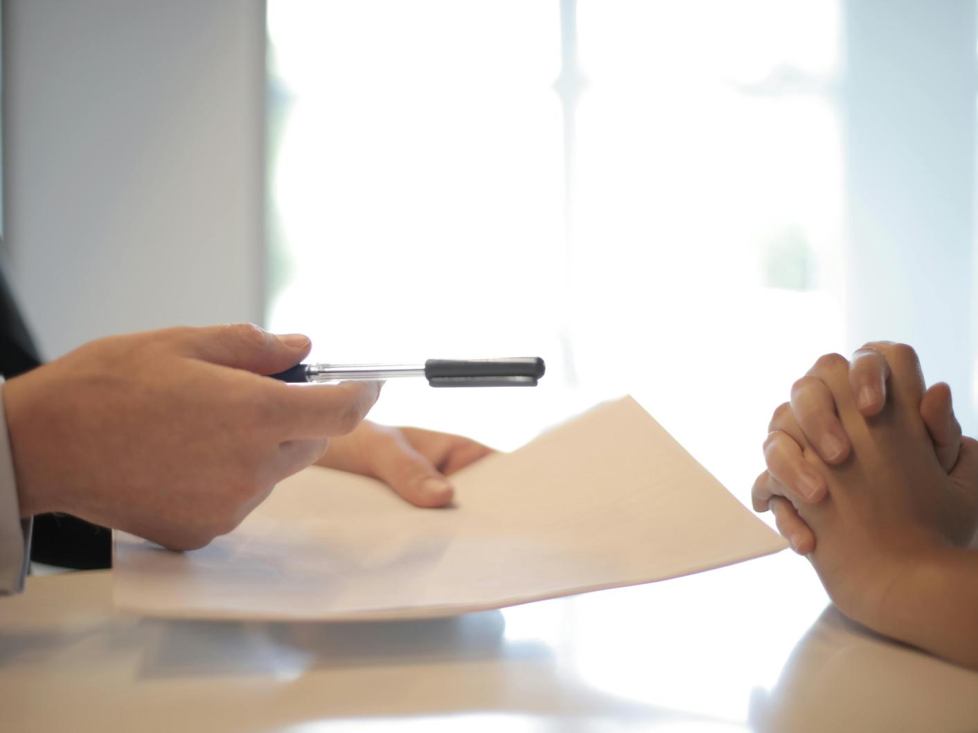 Solicitor giving will to woman to sign