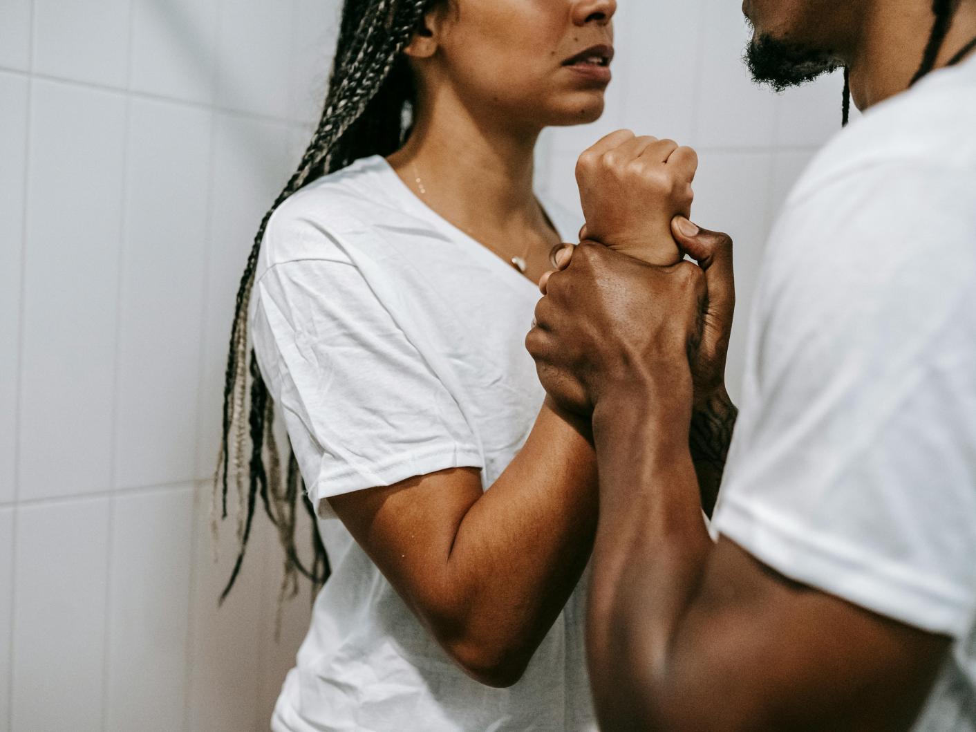 Black couple arguing together in bathroom